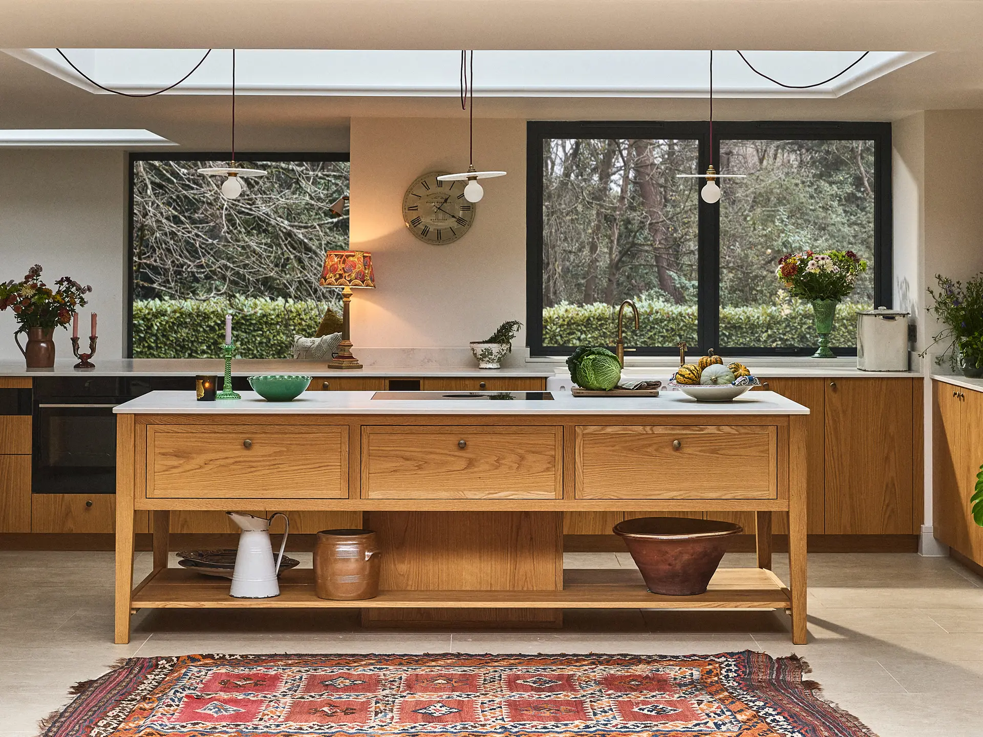 A country kitchen with a majestic Oak work table and a walk-in pantry designed and made by Pluck.