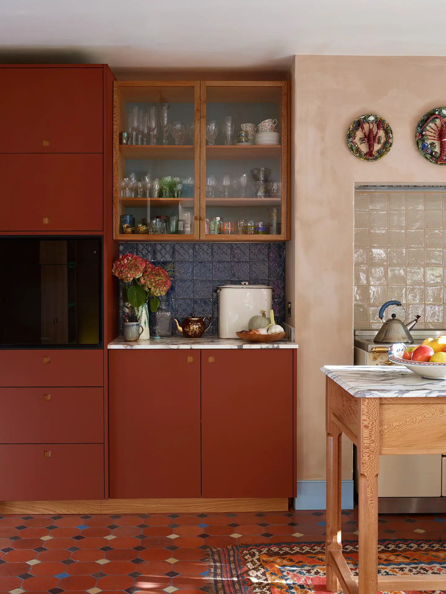 Pluck glazed cabinet with metal handles.