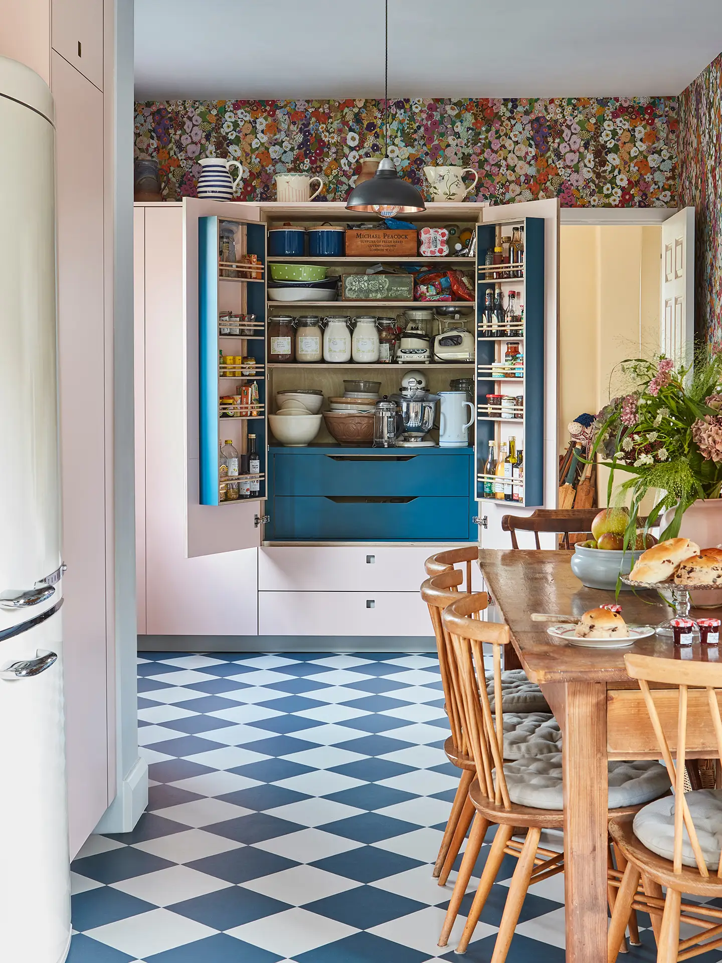 Pluck-Larder-Cupboard-with-pink-and-blue Pink Pluck larder cupboard with it's doors open revealing a blue interior and lots of ingredients.