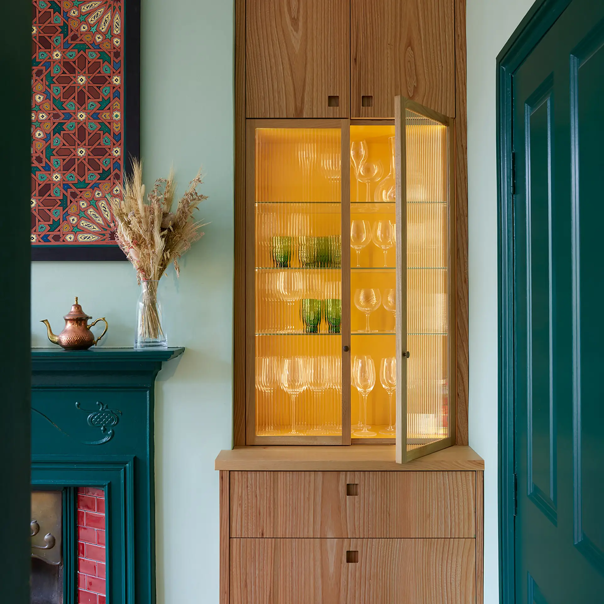 Built-in cabinetry within a chimney alcove, designed and made by Pluck.