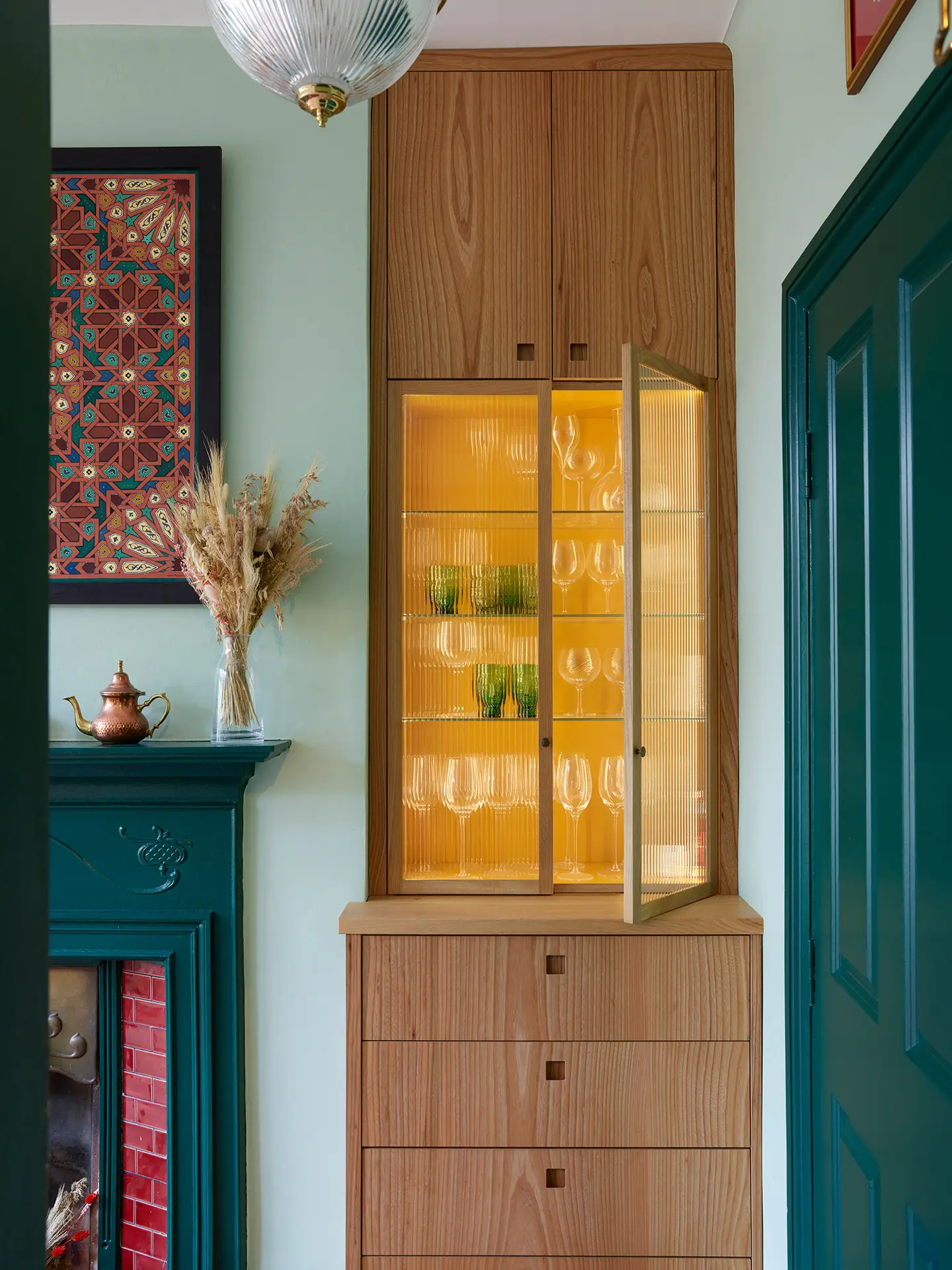 Built-in cabinetry within a chimney alcove, designed and made by Pluck.