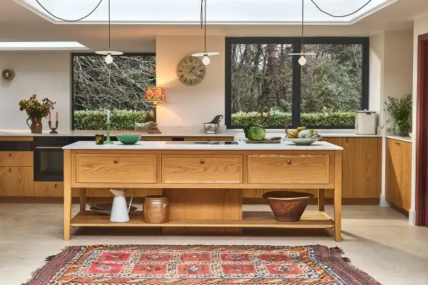 A country kitchen with a majestic Oak work table and a walk-in pantry designed and made by Pluck.