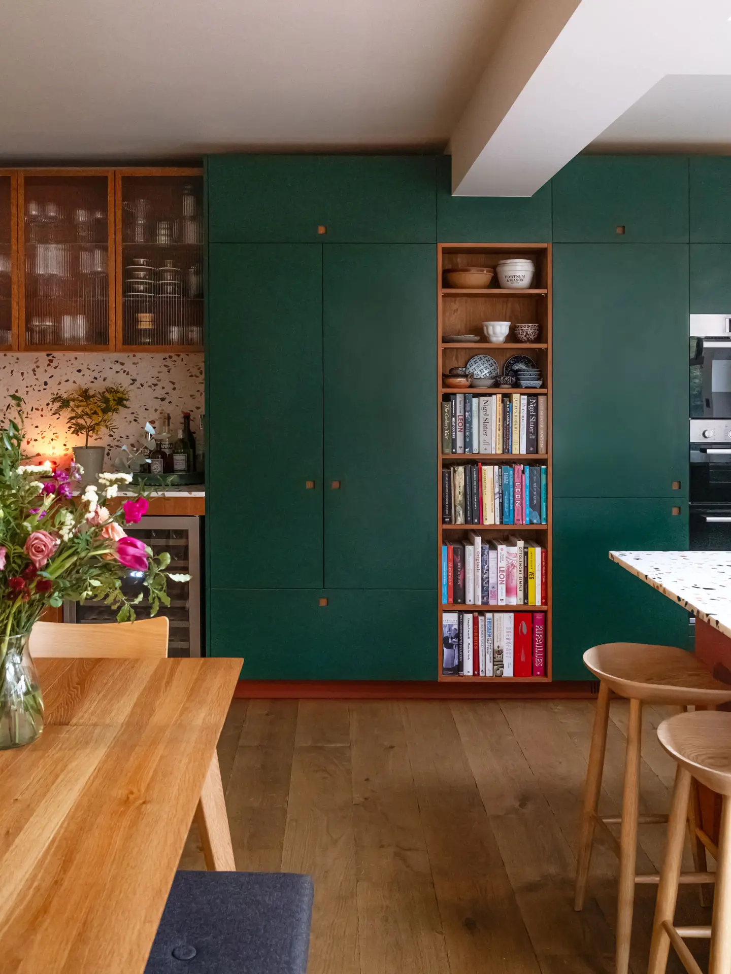 A Pluck kitchen in Essex with autumnal hues, part of an open plan space for a family with young children.