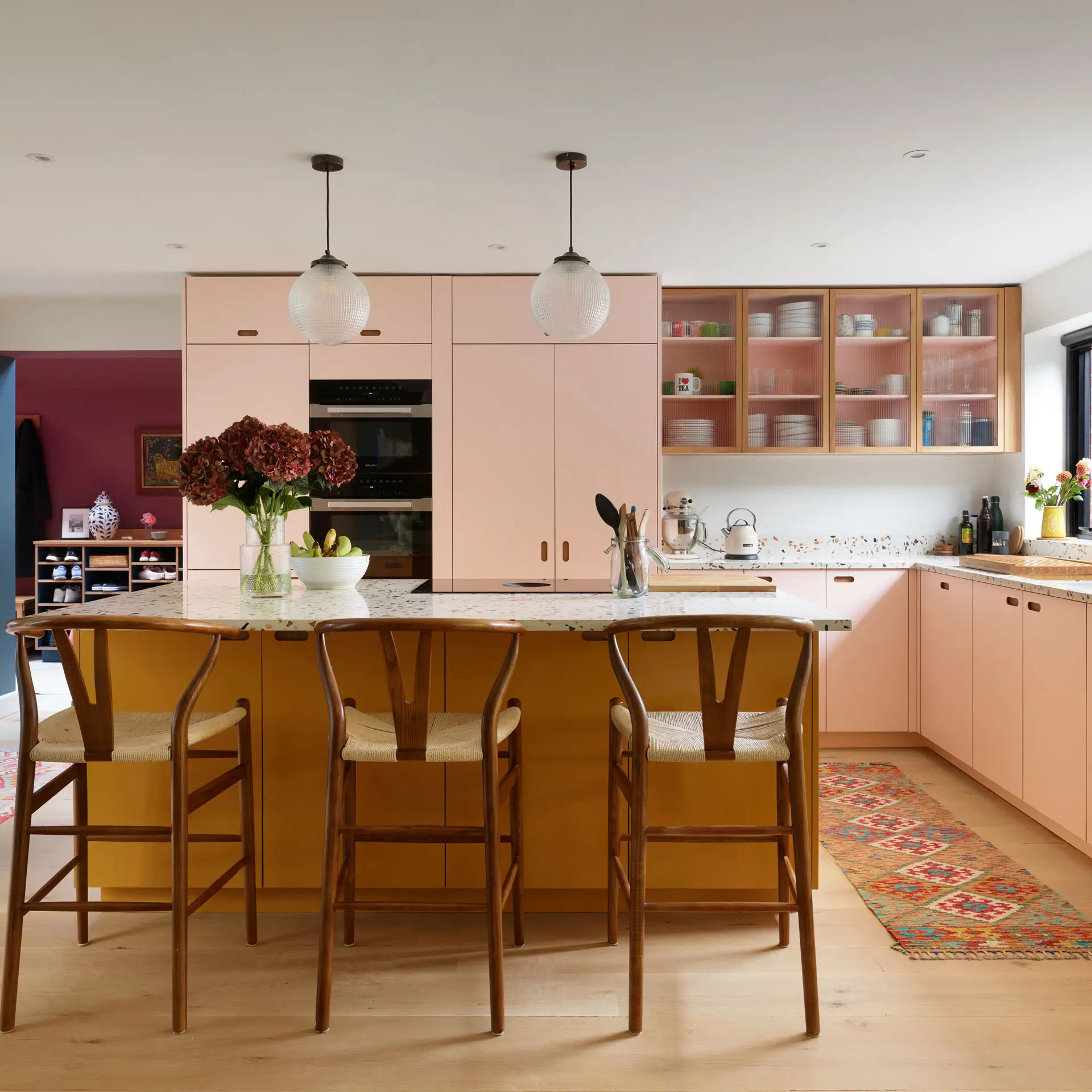 Pluck-Kitchens-Journal-The-Harpenden-Family-Kitchen-SQ-4 Colourful family kitchen in Hertfordshire including soft pink and mustard yellow Pluck cabinets, a large island and navy blue walls.