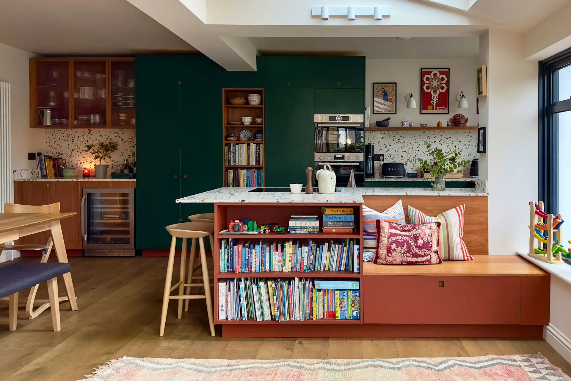 Pluck's Terracotta, Bonnington Green and Cherry wood cabinetry in a family kitchen in Essex with terrazzo worktops.