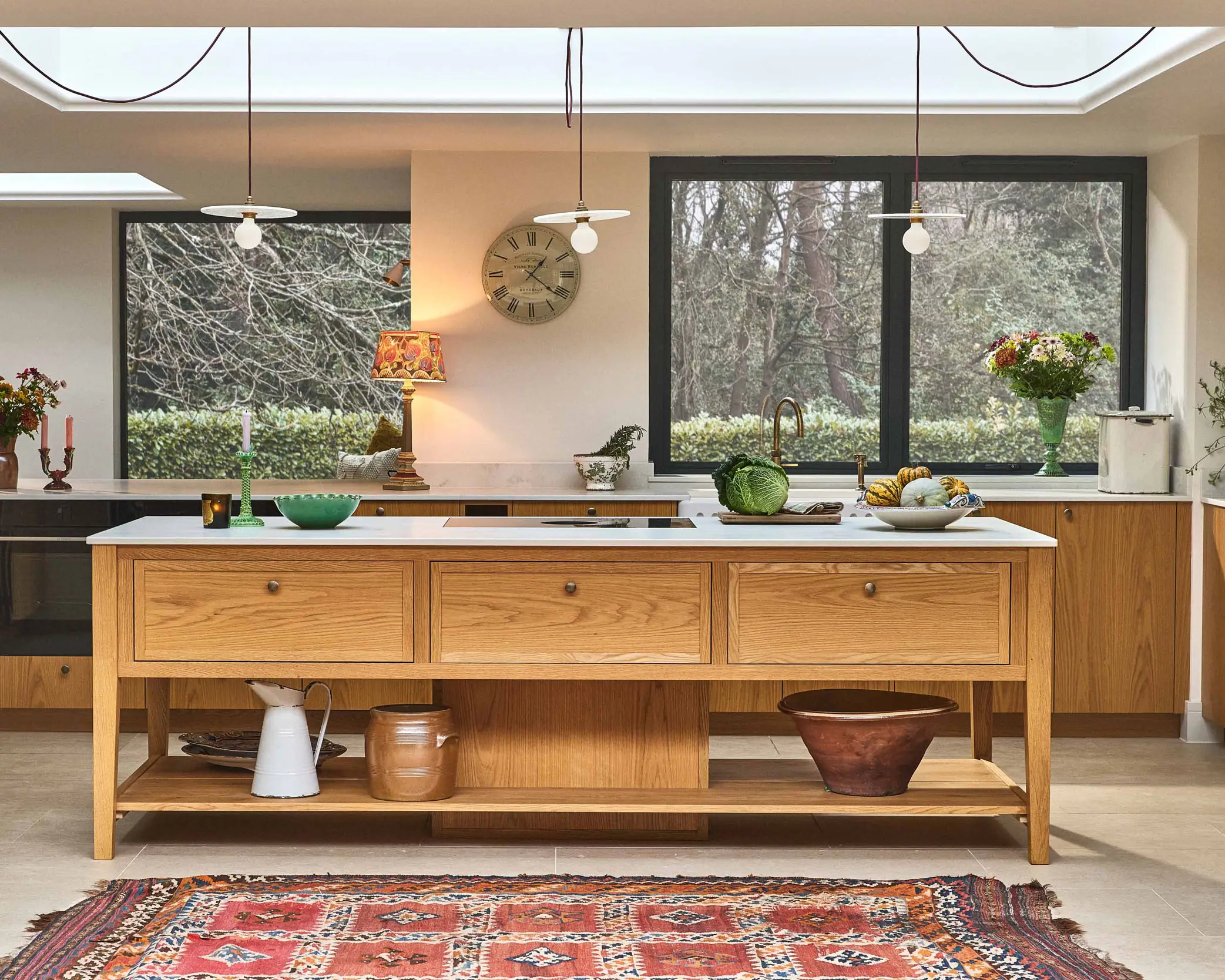 Large country kitchen with a central cook's table in Oak.