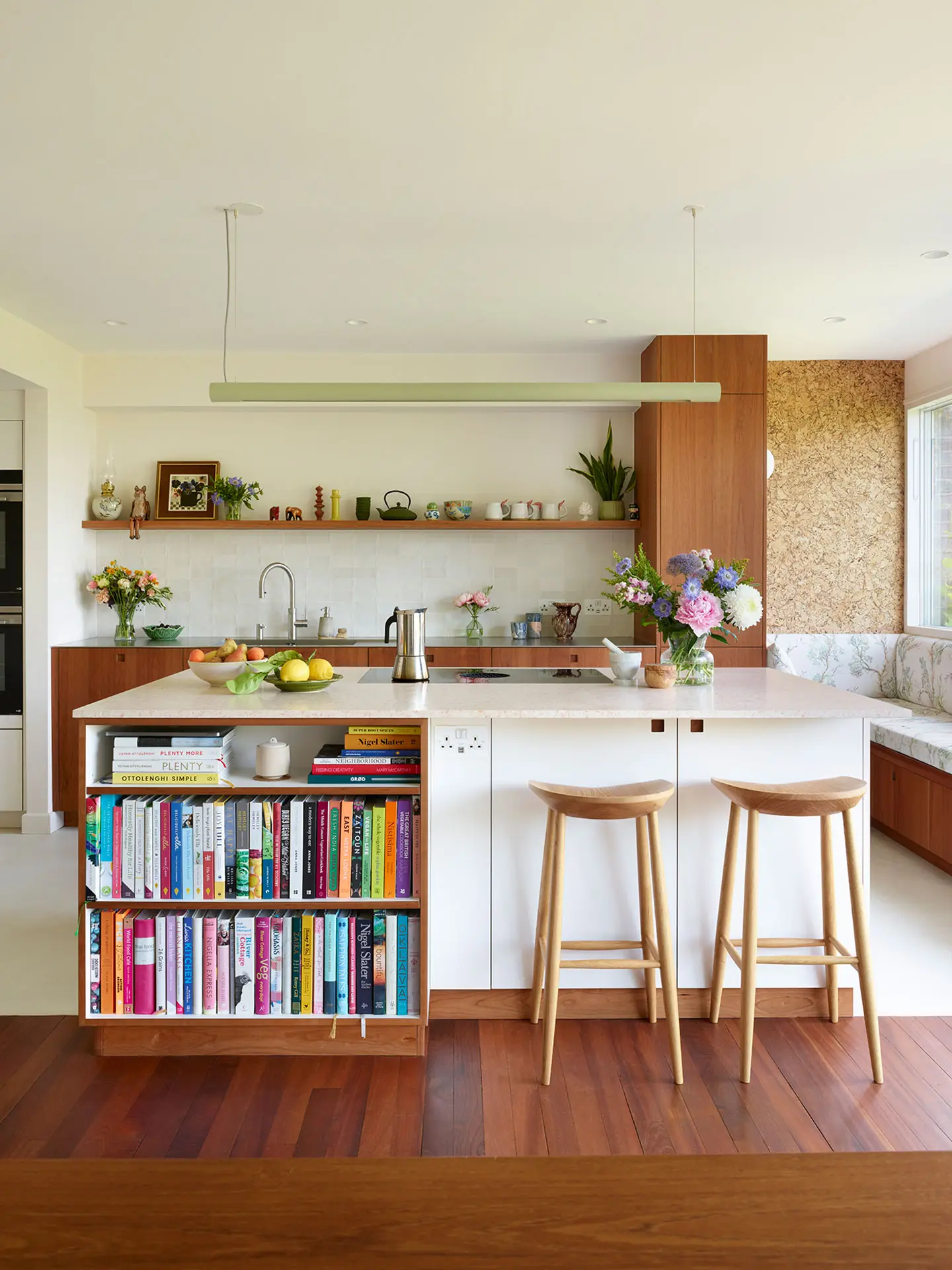 A Pluck kitchen in London with white and cherry wood custom cabinetry and a soft pink utility.