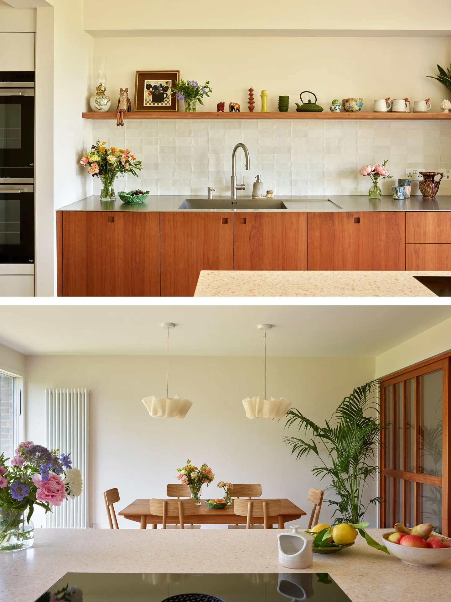 White, cherry wood and pink cupboards in a london kitchen by Pluck, with an island and dining area.
