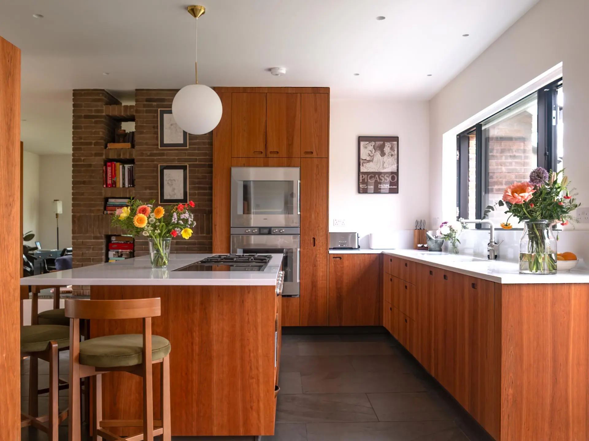 Warm cherry wood Pluck cabinetry including an island in an open plan London family home.