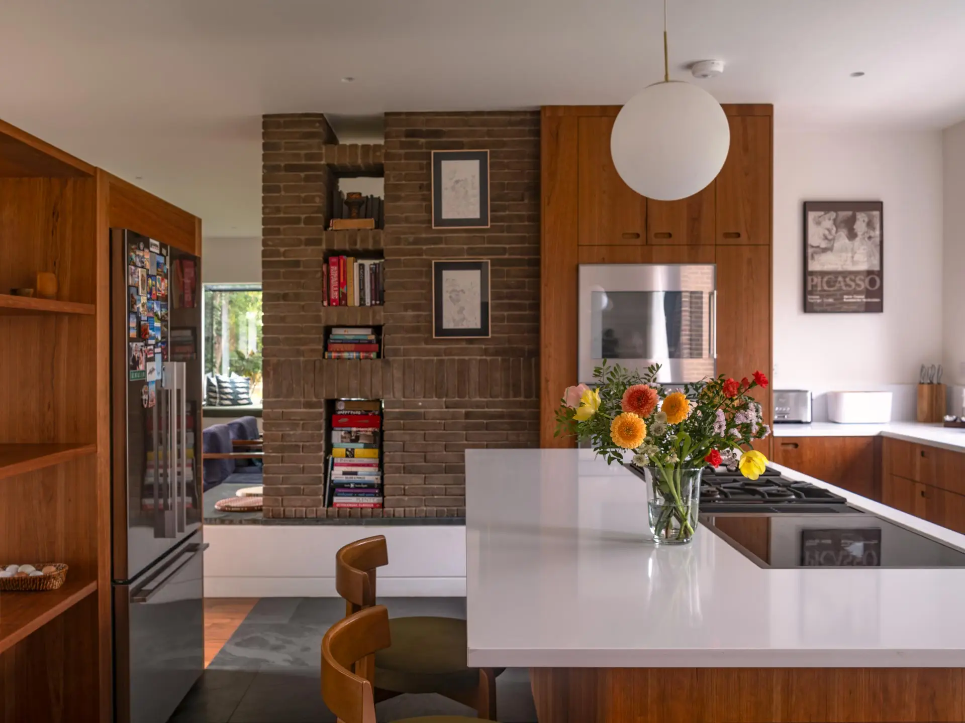 Warm cherry wood Pluck cabinetry including an island in an open plan London family home.