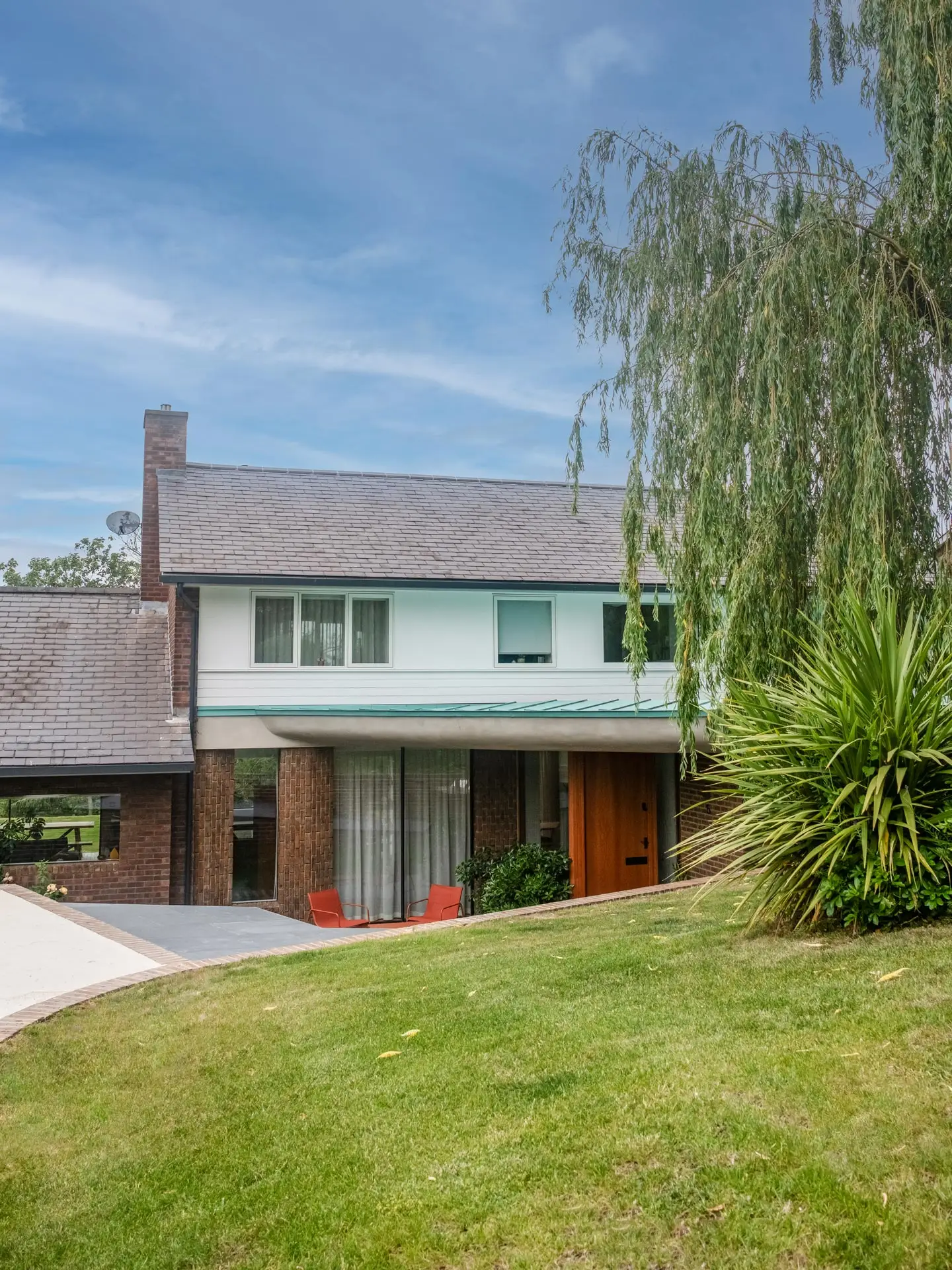 The exterior of a London home with a warm cherry wood Pluck kitchen including an island.