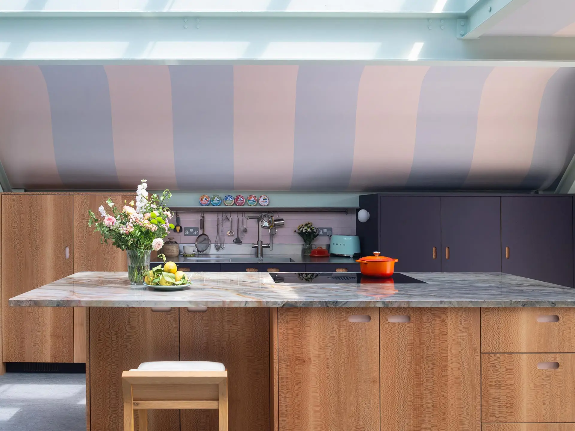 A London Mews house with custom cabinetry by Pluck, nestled underneath curved ceilings with painted stripes.